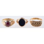 A group of three 9ct rings, a 9ct yellow gold ring set with an oval-cut red stone cabochon,
