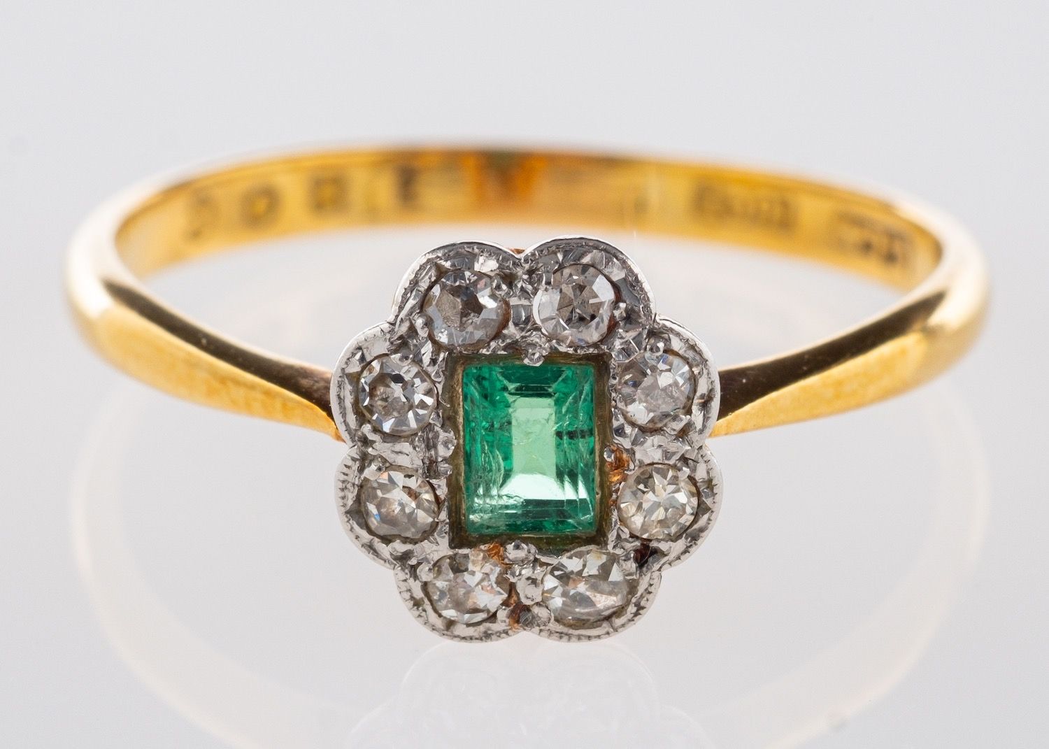 An emerald & diamond cluster ring,