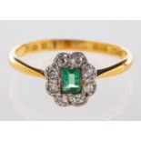 An emerald & diamond cluster ring,