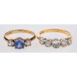 Two 9ct yellow gold rings, a three stone ring set with circular-cut blue and white paste stones,