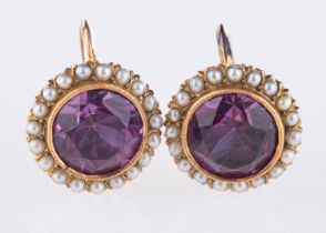 A pair of cluster designed earrings, each set with a circular-cut synthetic alexandrite,