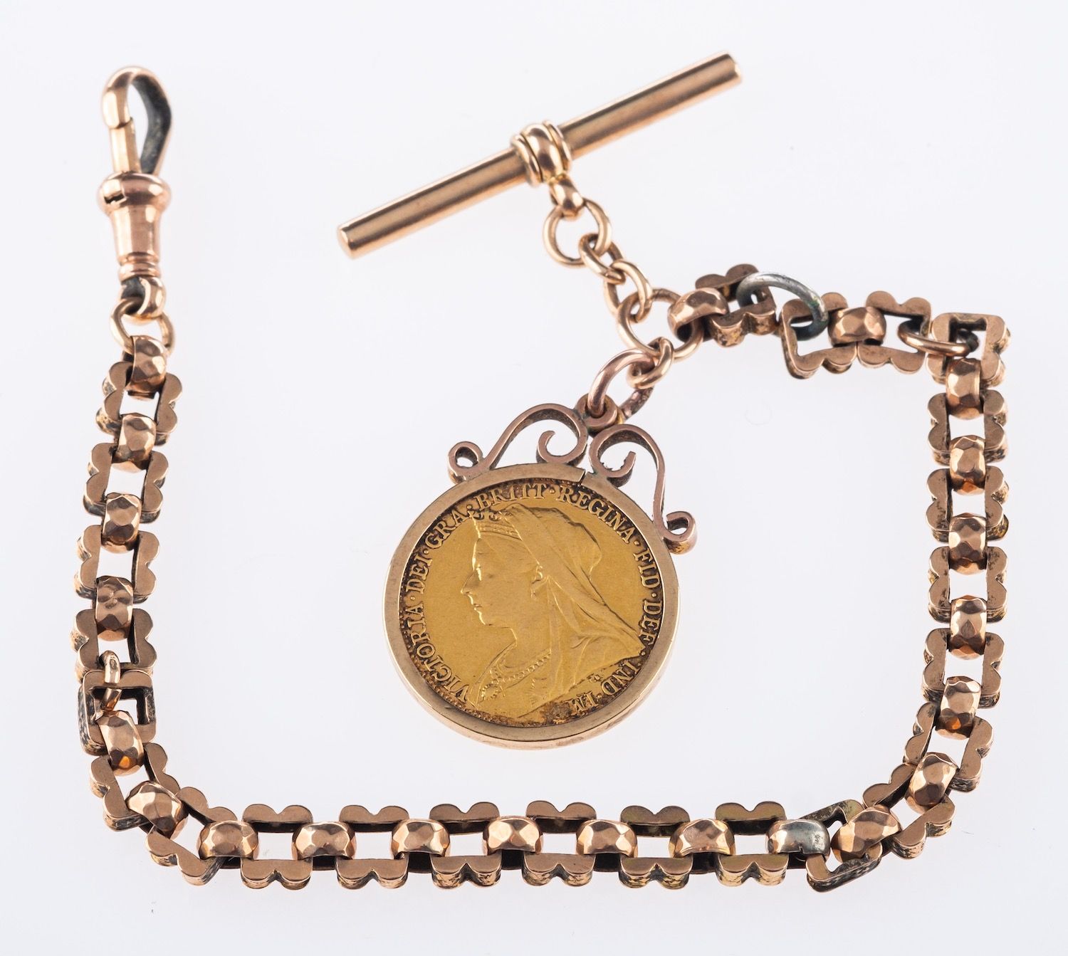 A Victorian sovereign and guard chain, a Victoria 1899 full sovereign in a gold mount,