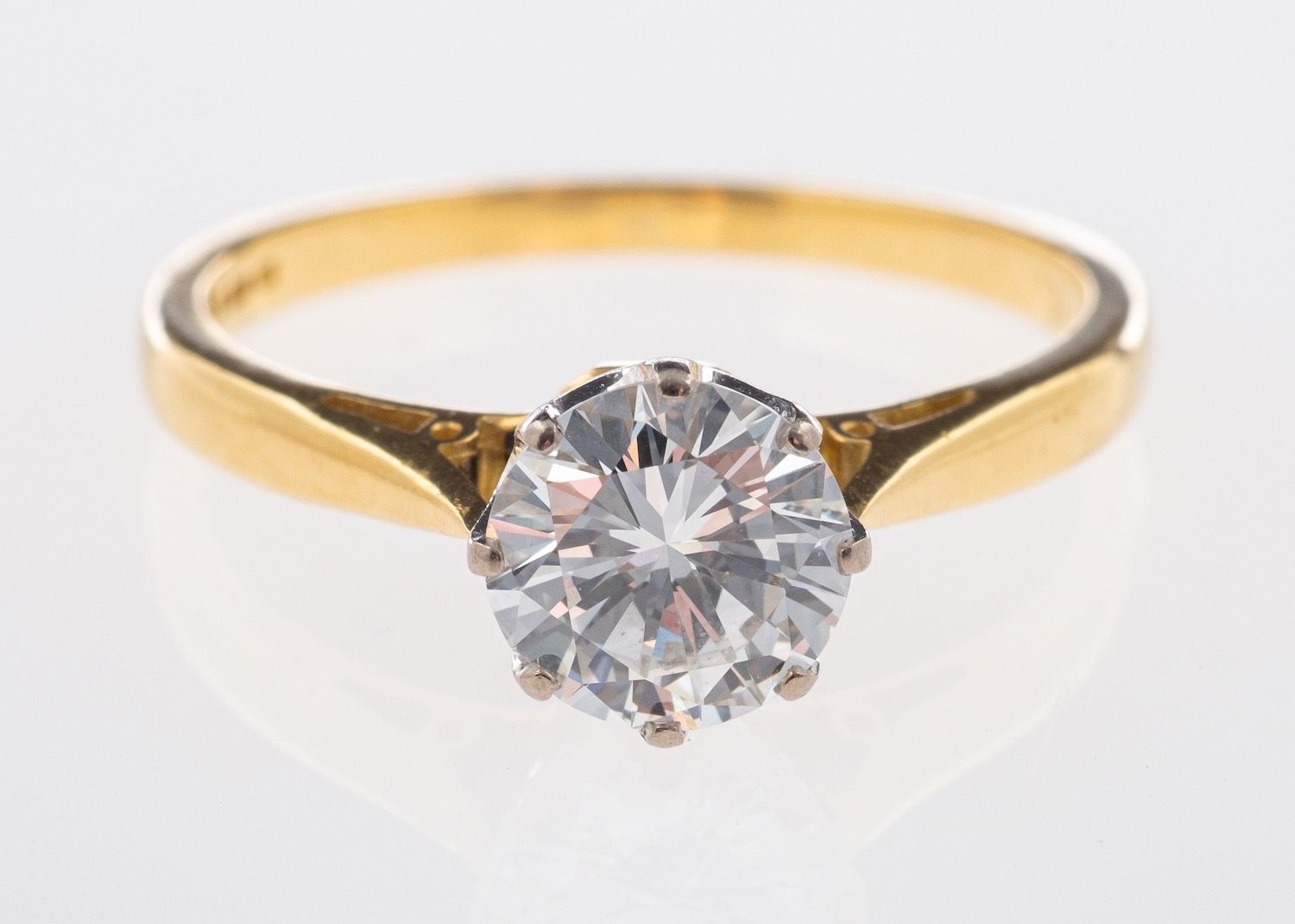 An 18ct yellow gold solitaire ring, set with a brilliant-cut diamond in an eight claw setting,