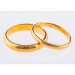 Two 22ct yellow gold wedding bands, both UK hallmarked, sizes M1/2 and M, total gross weight 6.