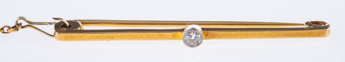 An antique diamond bar brooch, set to the centre with an old-cut diamond, safety chain,