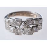 An Art Deco ring, of graduated geometric square design set with old mine-cut diamonds,