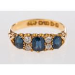 An 18ct yellow gold three stone ring, set with oval cut sapphires,