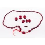WITHDRAWN LOT A 1920's red bead necklace, a string of graduated red beads, string broken,