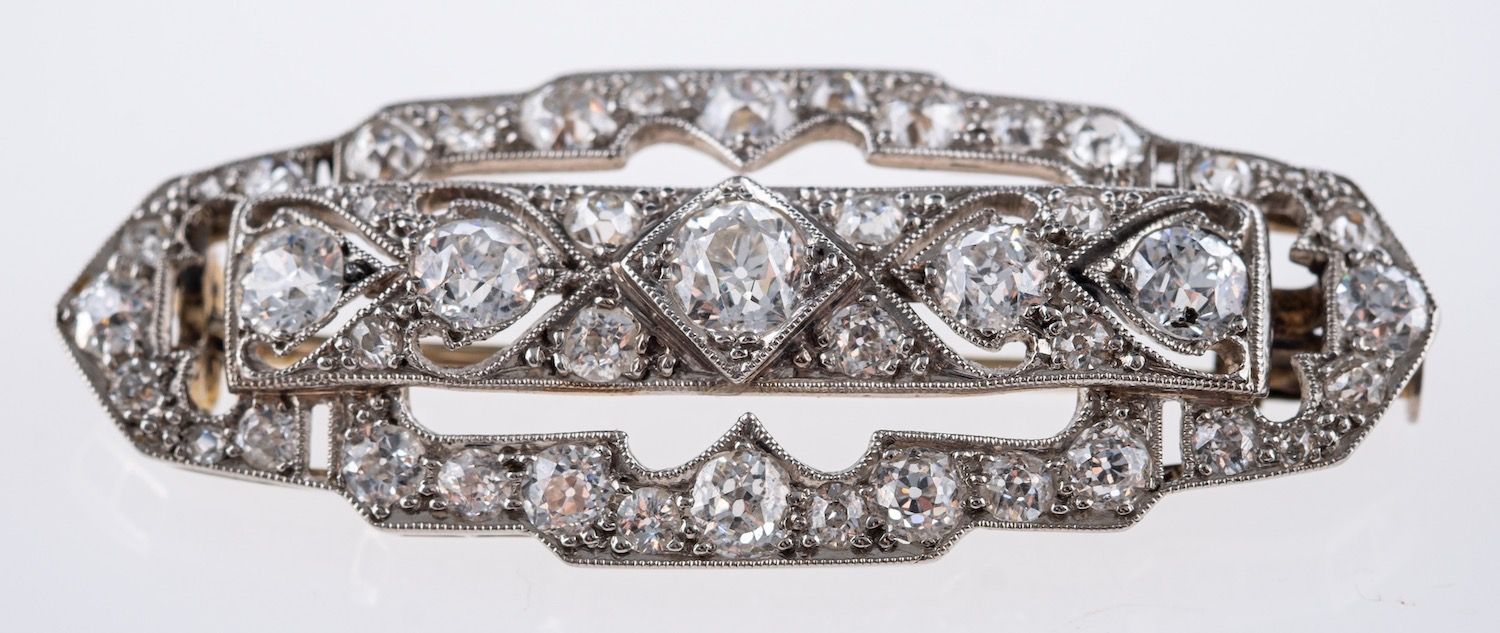 An Art Deco brooch, of openwork geometric design, milgrain set with old-cut diamonds,