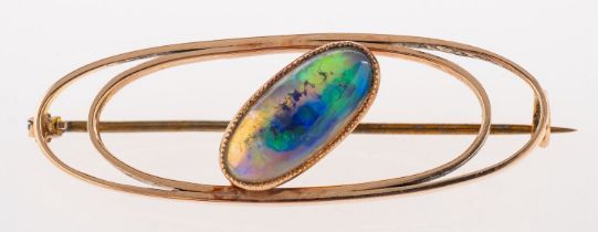 A stylised oval opal brooch, an openwork brooch set with an elongated oval opal cabochon,