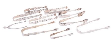 Four George III silver cast sugar tongs, with differing piercings,
