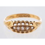An 18ct yellow gold ring, set with five old-cut diamonds in an open work and scroll setting,