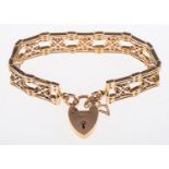 A fancy link gate bracelet of openwork articulated design with a heart padlock clasp and safety