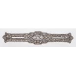An early 20th century diamond brooch, the panel with pierced scroll detail,