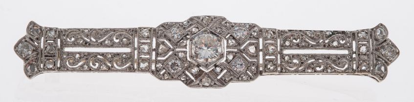 An early 20th century diamond brooch, the panel with pierced scroll detail,