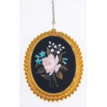 A Pietra Dura brooch, of flower and foliate design with a fancy gilt mount, safety chain,