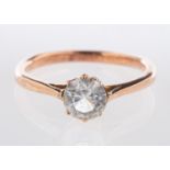 A single stone ring, claw set with a circular-cut white paste stone, unmarked, tests as 9ct gold,