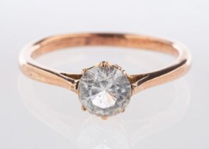 A single stone ring, claw set with a circular-cut white paste stone, unmarked, tests as 9ct gold,