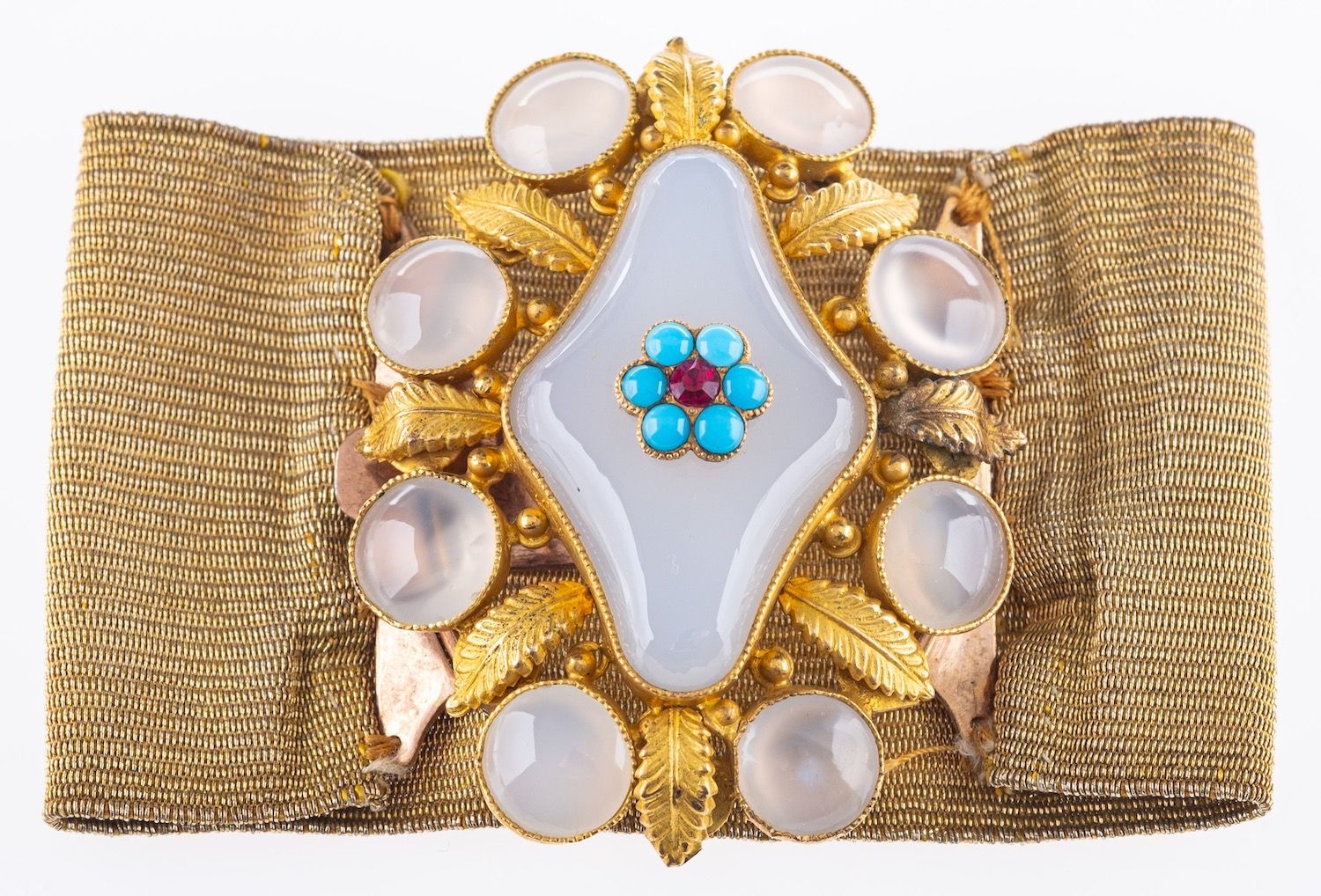 A Regency period bracelet, the buckle of flower and foliate design, set with white chalcedony,