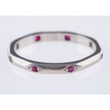 An Art Deco wedding band, of octagonal shape and interspaced with eight circular-cut rubies,