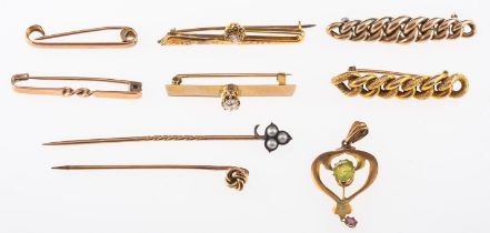 A collection of antique brooches and stick pins,