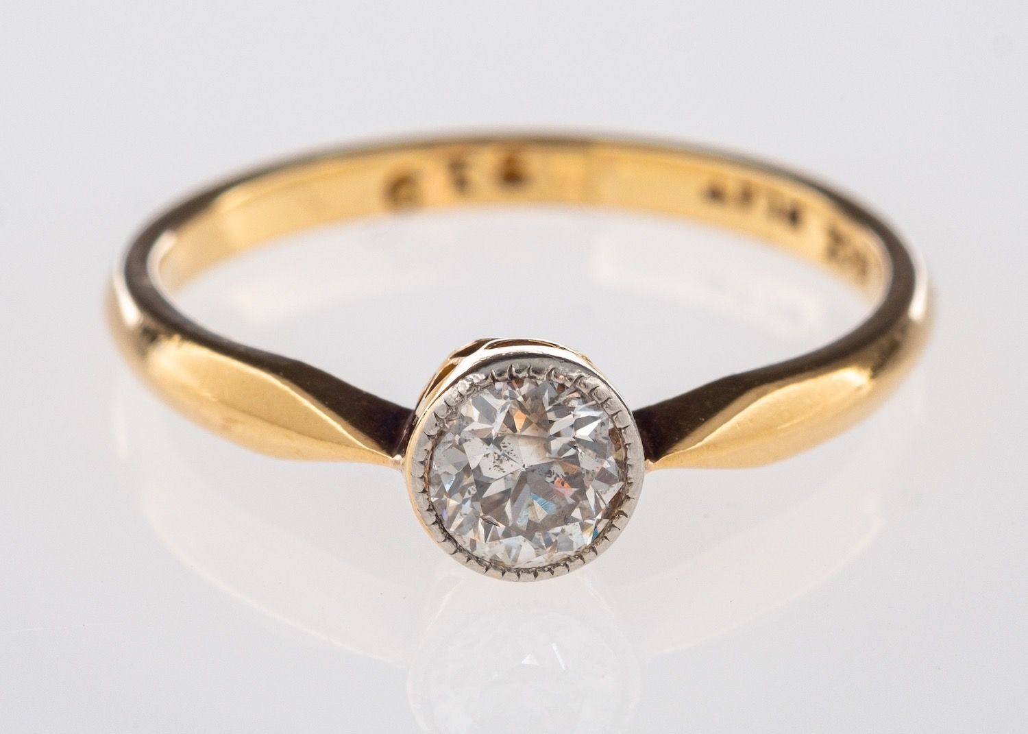 A solitaire ring, milgrain & bezel set with an old brilliant-cut diamond, diamond approx. 0.