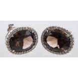 A pair of cluster earrings, each set with an oval mixed-cut smokey quartz,