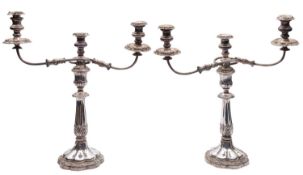 A pair of Sheffield plated silver candelabra, un-marked, each with three detachable scones,