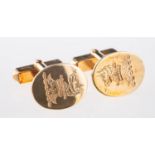 A pair of cufflinks, of oval design with crest engraving,