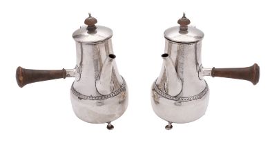 A pair of Arts and Crafts hammered silver café au lait pots by Phillip Hanson Abbott.