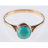 A 9ct yellow gold turquoise ring, collet set with a circular cut turquoisecabochon, UK hallmark,