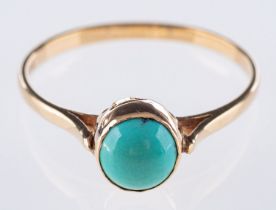 A 9ct yellow gold turquoise ring, collet set with a circular cut turquoisecabochon, UK hallmark,