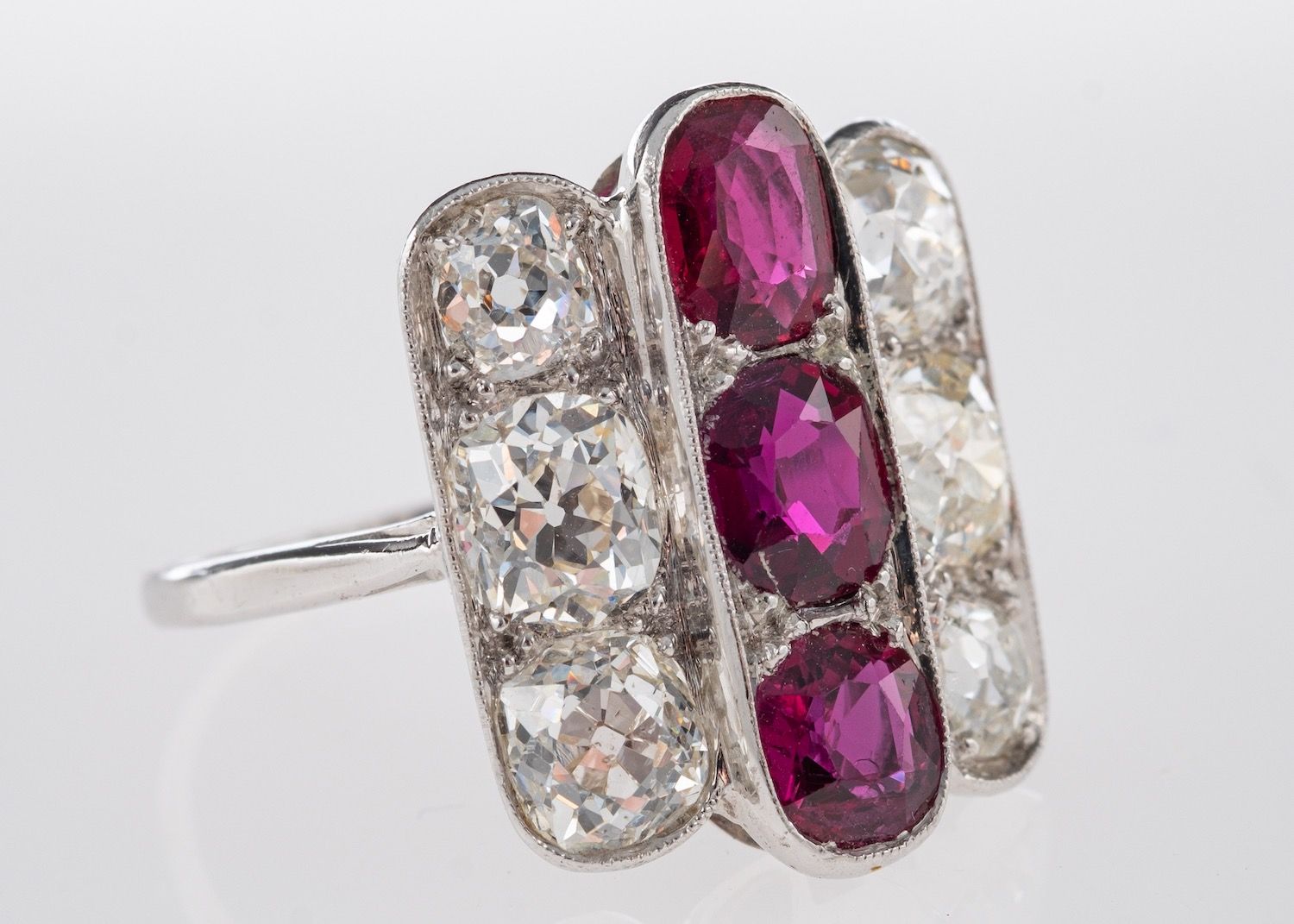 An Art Deco Ruby & Diamond Ring, a geometric designed three row ring,