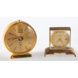 Jaeger, a small gilt travelling alarm clock the dial with baton numerals,