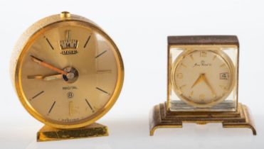 Jaeger, a small gilt travelling alarm clock the dial with baton numerals,