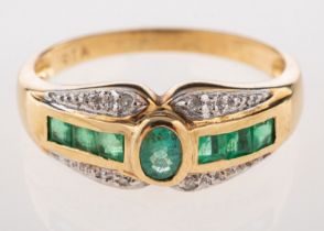 A 9ct emerald and diamond ring, set with an oval-cut emerald,