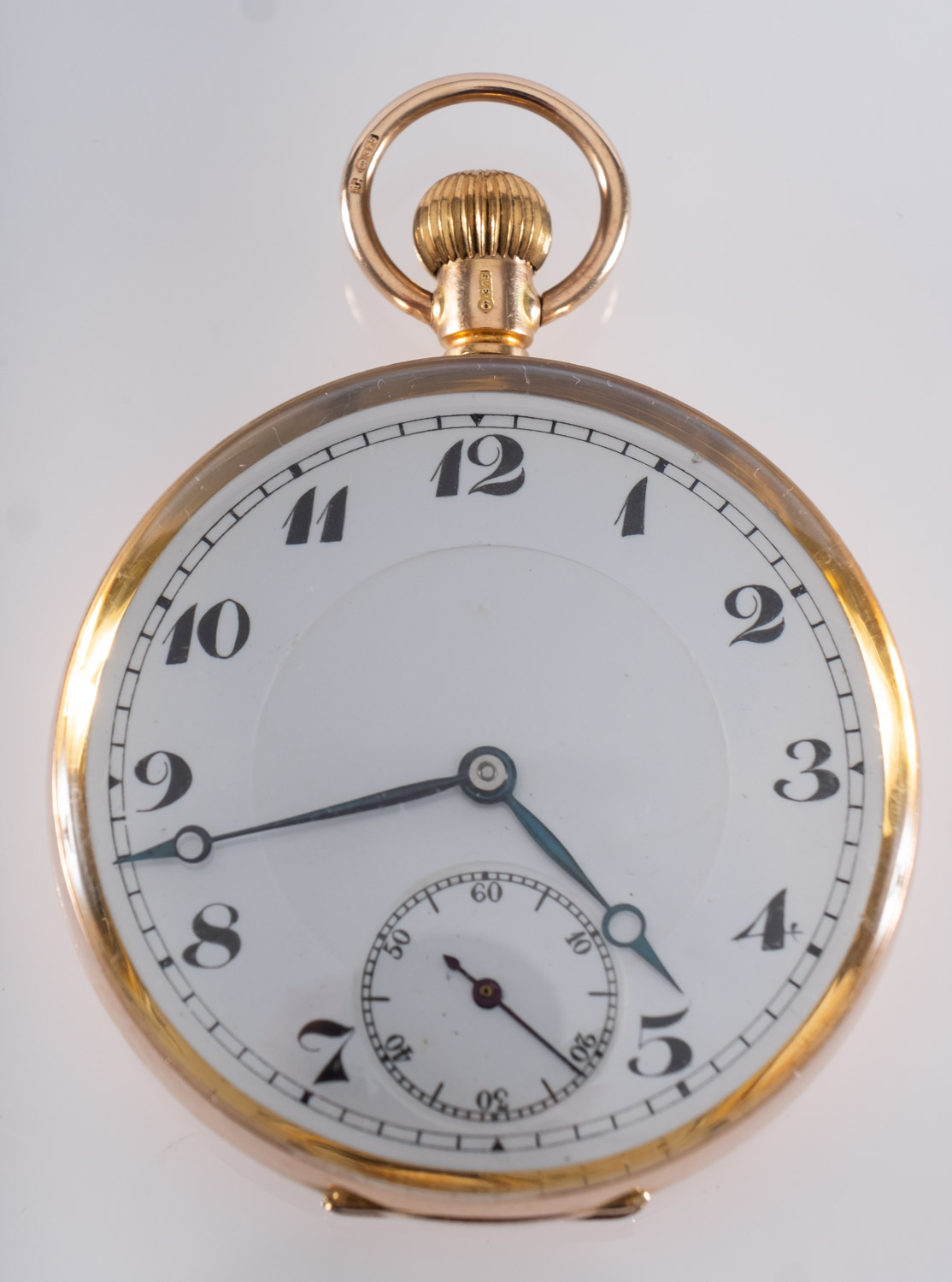 A 9ct gold open-faced pocket watch the round white enamel dial having black Arabic numerals,