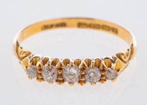 An 18ct yellow gold antique five stone ring, set with graduated old mine-cut diamonds, UK hallmark,