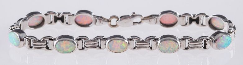 An opal bracelet and matching pendant, the bracelet is set with nine oval opal cabochons,