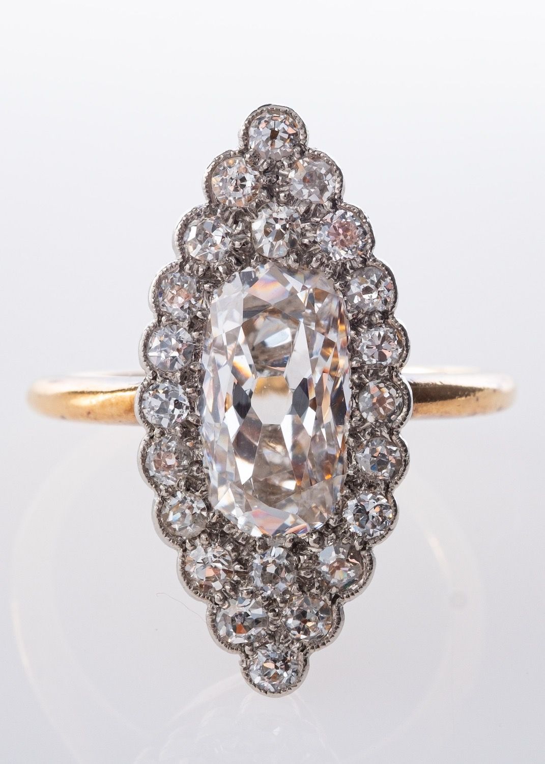 A marquise shaped cluster ring set centrally with an elongated oval-cut diamond, diamond approx. 1.