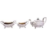 A George III silver three piece tea service by Robert Hennell II, London 1816, barge shape,
