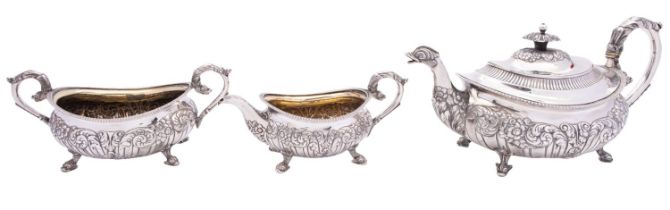 A George III silver three piece tea service by Robert Hennell II, London 1816, barge shape,
