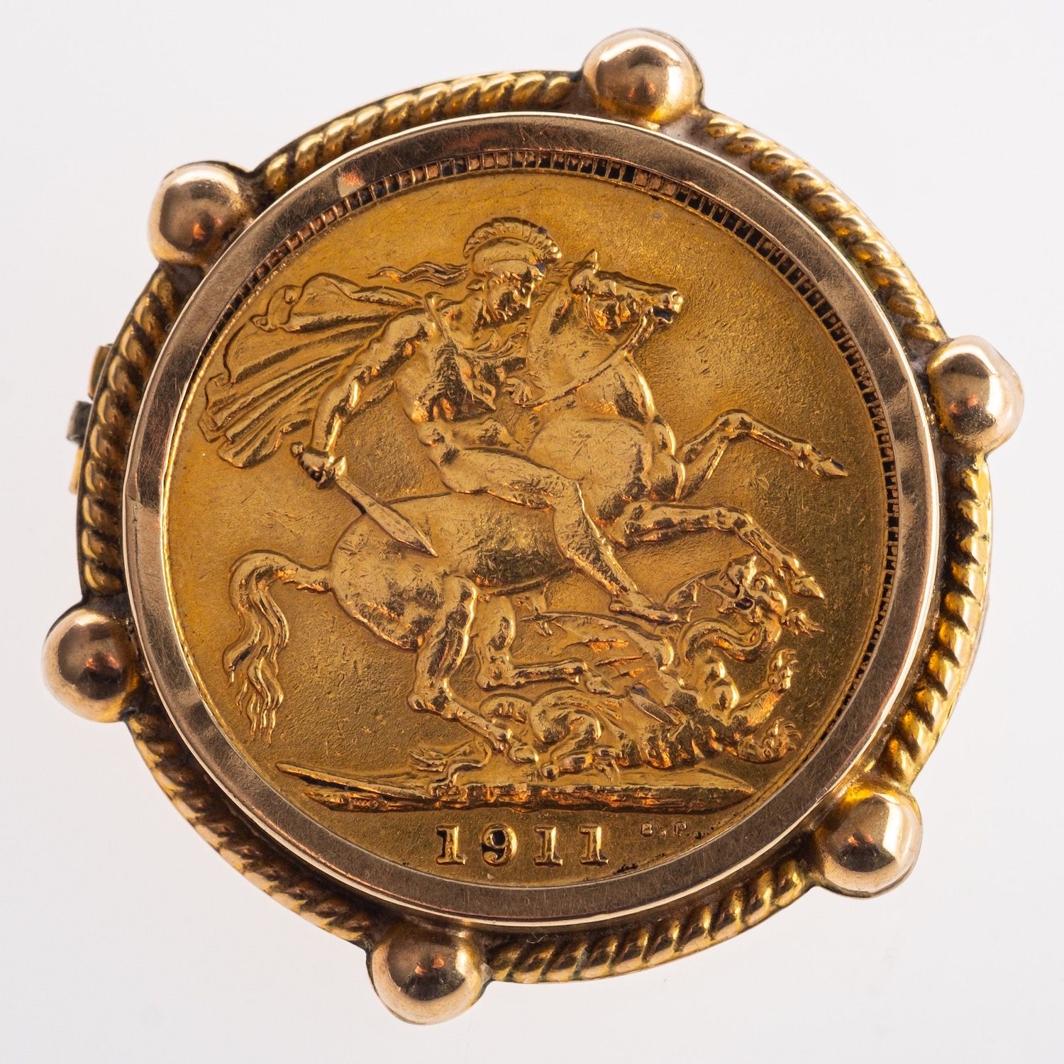 A full sovereign in brooch mount, a George V 1911 full sovereign in a rope edged mount,
