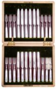 A set of twelve Edward VII silver and mother of pearl dessert knives and forks by Elkington & Co,