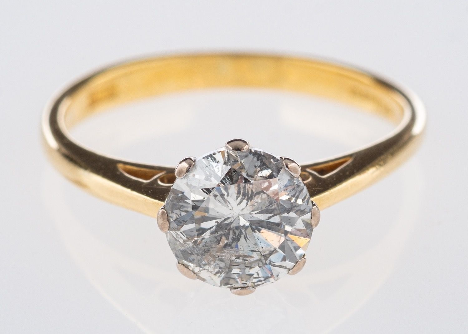 An 18ct gold diamond solitaire ring, set with a brilliant-cut diamond in an eight claw setting,