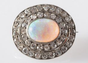 An opal and diamond brooch, set with an oval opal cabochon,