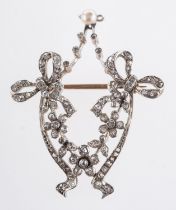 An Edwardian brooch in the form of ribbons and flowers, set with rose-cut and old mine-cut diamonds,