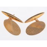 A pair of 9ct yellow gold cufflinks, oval in shape with engine turned engraving,