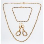 A matching suite of jewellery, to include a two-colour herringbone style flat snake chain necklace,