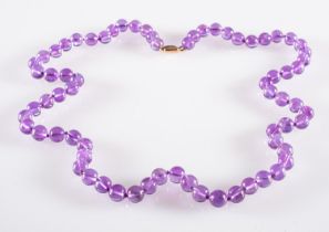 An Amethyst bead necklace, circular 8mm amethyst beads to a 9ct yellow gold clasp, clasp marked 9ct,